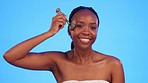 Jade roller, skincare and face of black woman in studio for wellness, anti aging and cosmetics on blue background. Portrait, massage and tool for girl model with luxury, beauty or lymphatic treatment