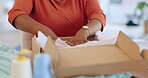 Black woman, hands and box in logistics for delivery, ecommerce or shipping cargo at office desk. Hand of African American female in small business packing product for shipment or courier service