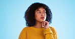 Confused, thinking and contemplating black woman in studio, pensive and wondering on blue background. Doubt, puzzled and unsure girl decide, choice or emoji on mockup, product placement or isolated