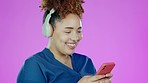 Typing on phone, music and black woman with headphones in studio to relax, chilling and happy. Smile, communication and face of girl on purple background with smartphone for chatting, text and online