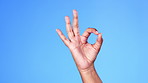 Hand, perfect and okay sign by person in support, vote or approve decision isolated against a studio blue background. Hands, yes and ok gesture by model showing signal of approval or agree