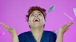 Face, dollars rain and winner woman in studio isolated on a purple background. Success portrait, achievement and happy female model with raining money, cash and winning lottery, prize or competition.