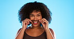 Hair, moustache and a playful black woman joking in studio on a blue background for fun or games. Portrait, face or haircare and a silly young female comic playing with her hairstyle in comedy