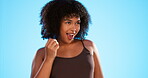 Black woman, dancing and happy with afro hair or natural curls on a blue background in studio. African female model person with beauty, self care and cosmetics with dance, smile and positive mindset 