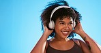 Music headphones, dance and black woman listening to rap, hip hop or jazz song for studio fun, freedom and wellness. Dancing energy, audio podcast or person streaming radio, media playlist or track
