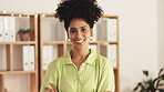 Portrait, happy and a business black woman arms crossed at work, standing in her office feeling confident. Face, smile and vision with a female employee looking motivated while working on management