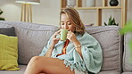 Happy asian woman drinking coffee on living room sofa for peace, calm mindset and easy lifestyle at home. Young female, smile and enjoy cup of tea, latte and hot cocoa on relaxing couch for self care