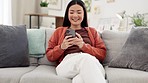 Asian woman, smartphone and laughing at funny meme on social media with communication and chat. Happy female using phone, typing and relax on sofa, comedy online and connectivity with technology