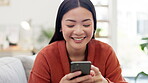 Asian woman, smartphone and laugh at funny meme on social media with communication and chat. Happy female using phone, typing and relax on sofa, comedy online and connectivity with technology