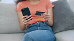 Woman, hands and phone with credit card on sofa for ecommerce, purchase or bank at home. Hand of female online shopping on smartphone relaxing on living room couch for internet banking or mobile app