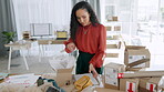 Black woman, box and logistics for delivery, ecommerce or packing cargo for shipping on office desk. African American female in small business packaging fashion product, shipment or courier service