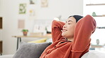 Asian woman, happy or relax on sofa in house, home or living room on weekend, day off or zen mental health. Smile, person or hands behind head on couch in peace, calm or self care mindset from break