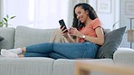 Woman on sofa, coffee and smartphone for social media, online reading and relax in living room. Female, happy lady and cellphone for connection, communication and app for chatting, texting or message