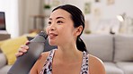 Fitness, Asian woman in lounge and drinking water after training, exercise and workout for wellness. Female, lady and athlete in living room, clear liquid and aqua for thirsty, hydration and practice