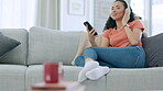 Headphones, phone and happy woman on couch listening to music for mental health, wellness or self care at home. Calm, relaxing and gen z person on sofa, cellphone and audio technology in apartment