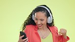 Headphones, smartphone and woman dancing, happiness and streaming music against a studio background. Female dancer, lady and headset for sounds, audio and listening to songs, movement and cellphone 