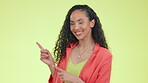 Promotion, advertising and a black woman pointing at mockup in studio on a green background for marketing. Portrait, product and presentation with an attractive young female showing blank mock up