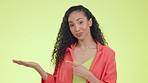 Face of happy woman pointing to mockup isolated on studio background for hand product placement or promotion. Person or biracial model portrait show mock up space, gen z information or advertising