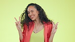 Happy, confident and peace sign with woman in studio for positive, empowerment and pride. Smile, wink and emoji with female and hand gesture on yellow background for emotion, opinion and cheerful