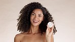 Face cream, skincare and black woman in studio for facial, mask or moisturizing wellness on brown background. Portrait, container and beauty product by happy model showing sunscreen while isolated