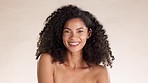 Skincare, beauty and face of a woman in a studio with a natural, cosmetic and facial treatment. Happy, wellness and portrait of a female model from Mexico with health skin routine by brown background