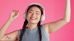 Happy woman, dancing and music headphones on isolated studio background for energy, freedom or expression. Smile, asian and fashion dancer listening to radio, podcast or audio on pink party backdrop