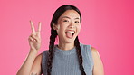 Happy, posing and face of asian woman in studio for positive, peace sign and frame. Focus, emoji and finger heart with girl and hand gestures on pink background for photography and satisfaction