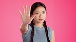 Asian woman, face or stop hands on isolated studio background for protest fight, vote or warning for women empowerment. Portrait, model or palm in no gesture to racism, discrimination or inequality