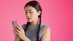 Serious, phone and text message with asian woman in studio for connection, concentration and typing. Browsing, news and app with girl and reading online for satisfaction, website and technology 