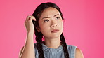 Asian woman, confused or thinking face on isolated studio background of skincare, beauty or makeup brand choice. Doubt, beauty or model finger with ideas, questions or choosing vision in mind change 