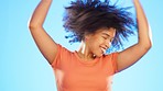 Black woman is dancing, freedom and happiness with fun, carefree with dance and rhythm on blue background. Excited, energy and wild, happy female dancer in studio, joy and crazy with positive mindset