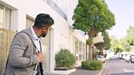 Businessman, waiting and crossing street in a city, calm and content on his commute to work. Looking, entrepreneur and indian male checking for safety traffic before enjoying a morning walk in London