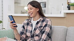 Phone, social media and laughter with a woman on a sofa in the living room of her home while reading a meme. Mobile, text message and a happy female enjoying a funny joke or humor on the internet