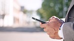 Hands, phone and businessman in city street, texting and search while outdoors for travel on blurred background. Smartphone, zoom and guy check online app for location, maps or directions on commute