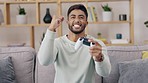 Gaming console, sofa and happy man winning, excited and goal in video game competition, speed challenge or online race. Gamer, winner or indian person play a fun game in his  living room or apartment