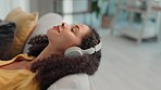 Relax sound, music and woman on a living room couch listening to audio on a sofa. Headphones, radio streaming and peace of a gen z person in a house on a home lounge feeling calm on a work break