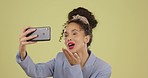 Selfie, happy and woman with a peace sign and blowing kiss isolated on a yellow background. Smile, playful and girl taking a photo for social media, profile picture and communication on a backdrop