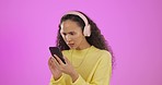 Headphones, phone and woman in studio with wow, bad and disappointed expression on purple background. Fake news, rumor and emoji by girl on smartphone app for social media, drama or podcast isolated