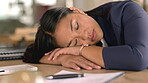 Tired woman sleeping on her desk in office with depression, burnout and mental health risk for project deadline or overworked. Business person, worker or employee sleep, fatigue and low energy