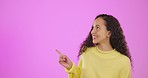 Advertising, mockup and portrait of a woman pointing isolated on a pink background in studio. Showing, introduce and girl marketing, doing advertisement or presentation on a space for recommendation