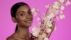 Beauty, organic skincare and Indian woman with flowers happy in studio, cosmetics and nature isolated on pink background. Natural makeup, dermatology and smile, model with spa or salon detox facial.