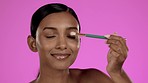 Beauty, cosmetics and eyeshadow, Indian woman in studio with brush in hand, skincare and isolated on pink background. Happy makeup routine, eye shadow and smile, model with luxury cosmetic product.