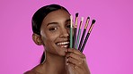 Beauty, makeup and Indian woman with brushes in studio, happiness and smile isolated on pink background. Skincare, dermatology and cosmetics, happy skin care model with luxury spa or salon product.