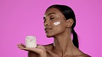 Skincare, face cream and woman with a jar in studio for a beauty, natural and skin routine. Wellness, health and model with facial spf, lotion or moisturiser for cosmetic treatment by pink background