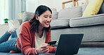 Asian woman, credit card and online shopping on laptop, digital fintech payment and customer budget in living room. Happy female, ecommerce and computer banking for finance, cash investment and sales