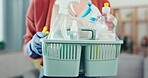 Woman, hands and detergent basket for cleaning, housekeeping and safety maintenance at home. Closeup female cleaner holding container of chemical bottles, products and liquid tools for maid service