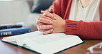 Woman hands, bible book and prayer in home of spiritual faith, holy gospel and worship of God. Closeup female praying with christian books, studying religion and praise of jesus christ, peace or hope