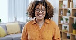 Happy, smile and face of a woman in a living room with happiness, laughing and calm. Laugh, smiling and portrait of a young girl standing in a lounge with positivity, enjoyment and confidence