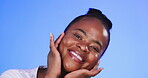 Black woman, hands on face and beauty portrait for skincare and cosmetics for glow and shine in studio. Happy aesthetic female model on a blue background for facial self care and makeup with a smile