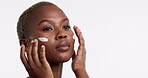 Beauty, skincare and lotion with a model black woman in studio isolated on a white background for antiaging. Face, skin and moisturizer with an attractive young female indoor to apply treatment